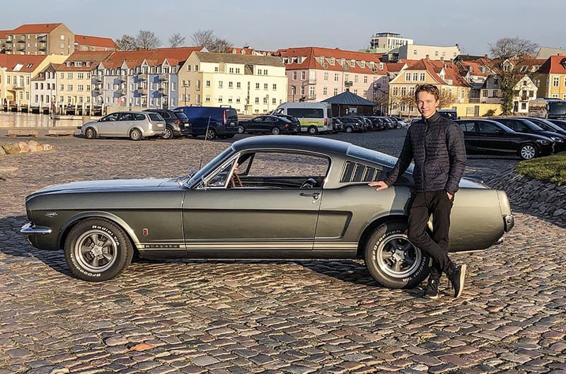 Johannes Mikkelsen standing with Mustang in Denmark